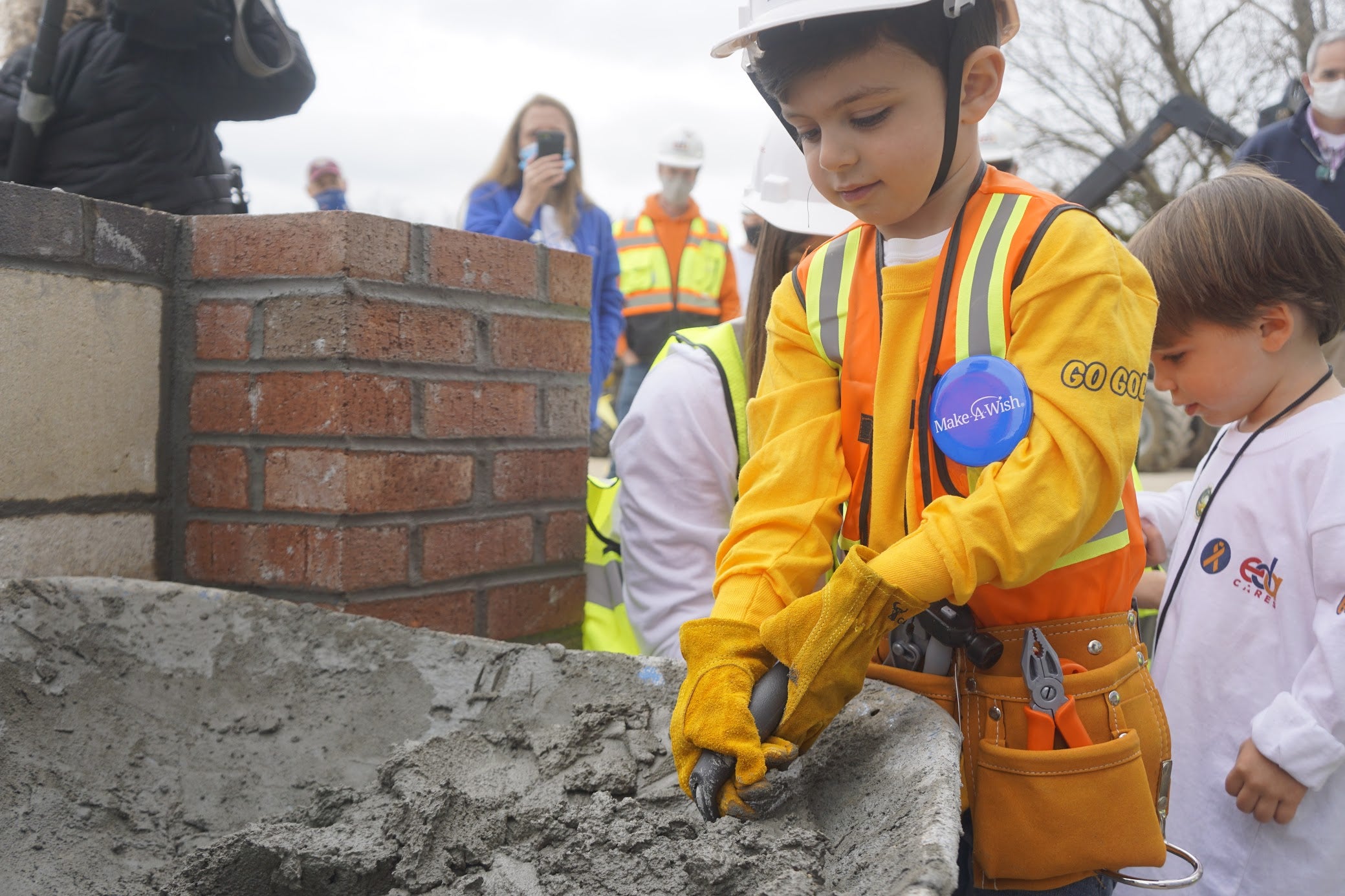 Nicholas Esposito getting a trowel full of mortar.